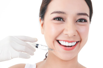 The doctor hand held the syringe to inject the girl's face to treat acne. Skin care beauty concept...