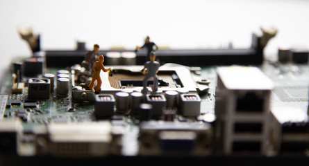 miniature people Motherboard and  CPU repair, Concept: working in technical teams,  technology systems Behind the maintenance engineering,  Computer Hardware  for memory, closeup mini top view