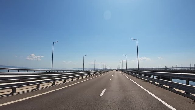 Driving along Crimean bridge through Kerch Strait to Crimea. Automobile and railway bridge connecting Taman and Kerch