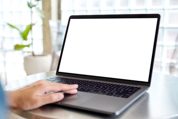 Fototapeta premium Mockup image of a woman using and touching on laptop computer touchpad with blank white desktop screen