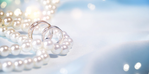 Wedding background with rings and pearls