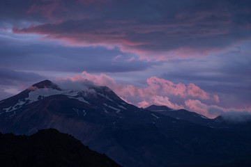 Mountain peak with snow and clouds during dramatic and colorful sunset on the laugavegur Hiking trail close to Thorsmork