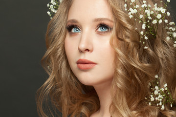 Fototapeta premium Portrait of perfect blonde woman with wedding hairdo on dark background
