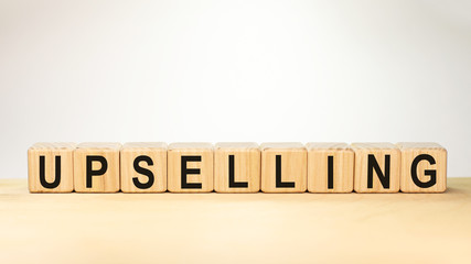 Word UPSELLING on wooden cubes on white background