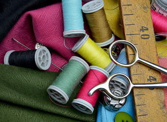 sewing accessories on a colorful fabric background