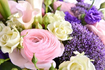Bouquet of spring flowers with beautiful pink ranunculus flower, pink berries and violet tender flowers. Soft focus. Spring time 