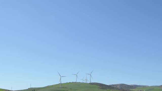 Landscape of wind turbines moving with blue sky a sunny day