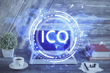 Double exposure of blockchain theme hologram and table with computer background. Concept of bitcoin crypto currency.