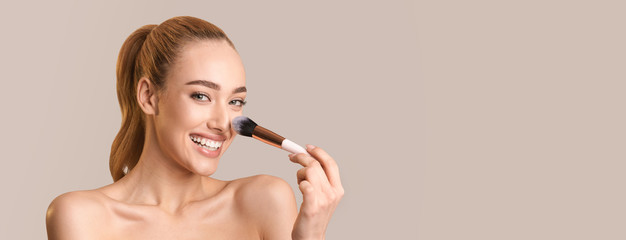 Woman Applying Face Powder Making Makeup Over Beige Background, Panorama