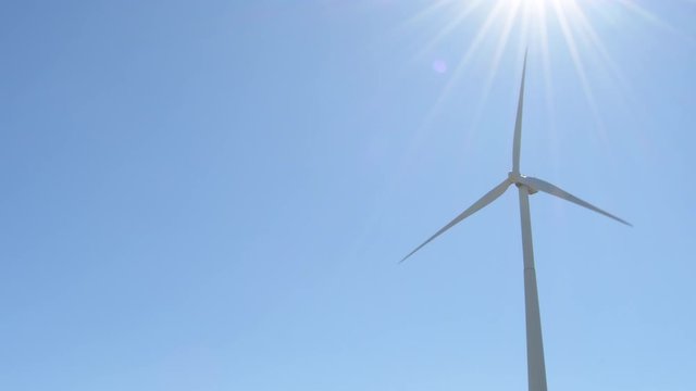 Wind turbine of renewable energy moving with blue sky a sunny day