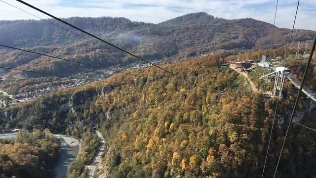 bungee jump at AJ Hackett Sky Park on mountain forest background. Extreme activities of Sochi 
