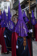 Christian Holy Week procession with Nazarenes and their hoods through the streets of the town