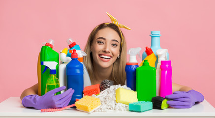 Arsenal for home cleaning. Housewife hugs cleaning supplies
