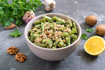 Salad with green beans and spicy walnut sauce in a bowl. Vegetarian, vegan menu.