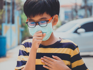 Little boy wearing mask for protect PM2.5, Corona virus and smog when go to outside and stop Corona...