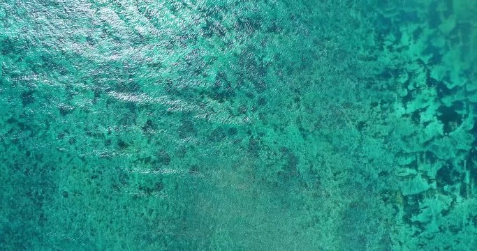 The turquoise blue sea at the Indonesian island of Lombok from the sky. a birds eye view over the shoreline of Lombok, Indonesia, south east Asia. Aerial view of the last untouched beaches