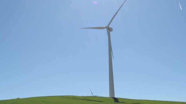 Big wind turbine of renewable energy moving with blue sky a sunny day