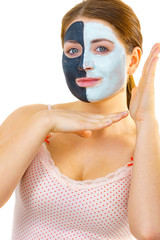 Girl with black white mud mask on face