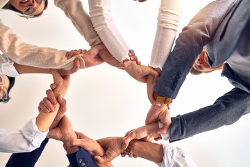 Group of business workers standing with hands together at the office
