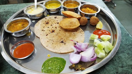 A big Maharaja thali served with lentils and salad.