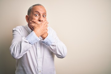 Senior handsome businessman wearing elegant shirt standing over isolated pink background shocked covering mouth with hands for mistake. Secret concept.