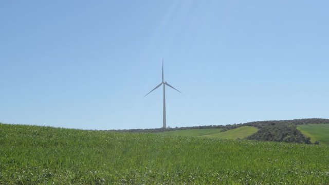 Landscape of wind turbine of renewable energy in the field moving with blue sky