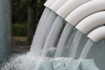Water flowing from white tubes, pipes background