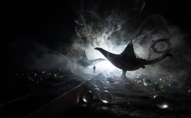 Silhouette of a man standing in the middle of the road on a misty night with giant Antique Aladdin...