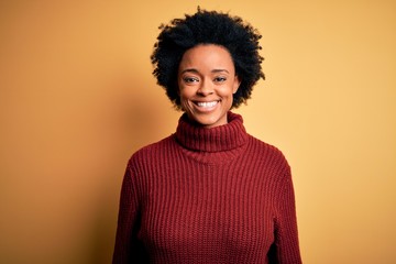 Obraz na płótnie Canvas Young beautiful African American afro woman with curly hair wearing casual turtleneck sweater with a happy and cool smile on face. Lucky person.