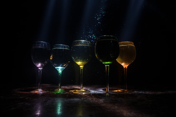 Goblet of white wine on wooden table on wooden wall background