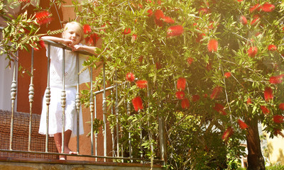Little girl enjoying summer time at the garden. Summer vacations.