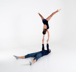 Duo Of Acrobats Showing hand to hand Trick, Isolated On White