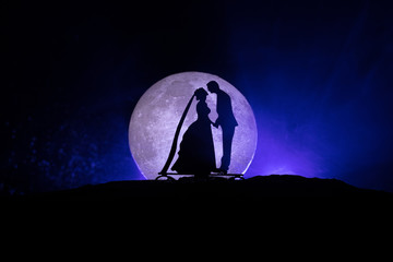 Young couple in love at beautiful moon of night.