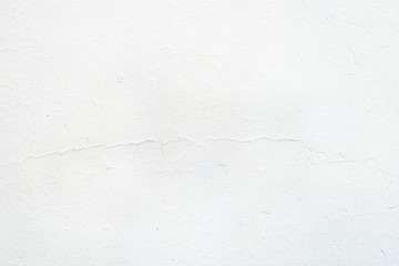 abstract background of an old concrete wall painted in white close up
