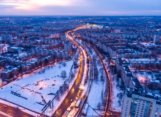 Fototapeta na wymiar Aerial city winter view with crossroads and roads, houses, buildings, parks. Helicopter drone shot. Wide Panoramic image. Kharkiv, Ukraine