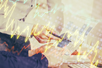 Financial trading graph double exposure with man desktop background.