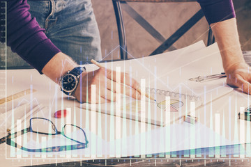 Financial trading chart double exposure with man desktop background.