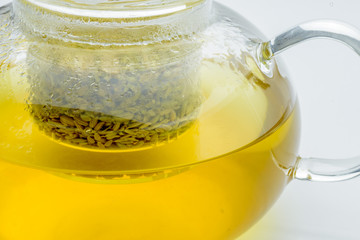 fennel seeds loose inside glass teapot brewed for healthy drink on white background