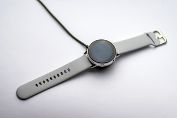 smart watch wireless charging on charging pad on kitchen worktop table