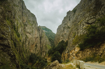 Cycling mountain road. Misty mountain road in high mountains.. Cloudy sky with mountain road