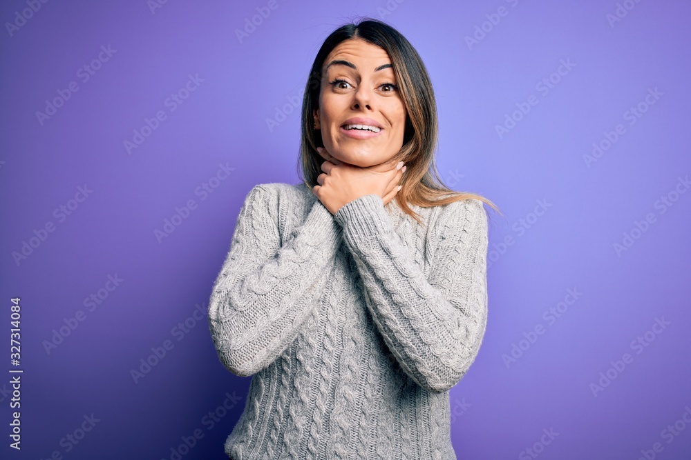 Sticker young beautiful woman wearing casual sweater standing over isolated purple background shouting and s