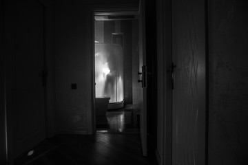 Horror silhouette of person in window. Scary halloween concept Blurred silhouette of witch in...