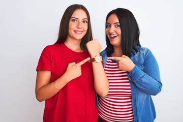 Young beautiful women wearing casual clothes standing over isolated white background In hurry pointing to watch time, impatience, looking at the camera with relaxed expression