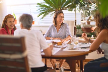 Young beautiful girl smiling happy and confident sitting dinking cup of coffee at terrace
