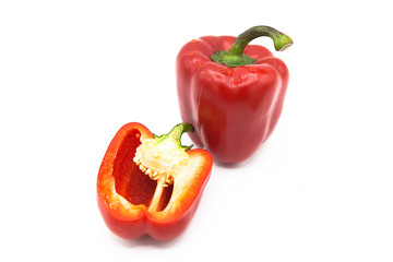 Ripe fresh organic bell peppers and half pepper in dew drops isolated on a white background