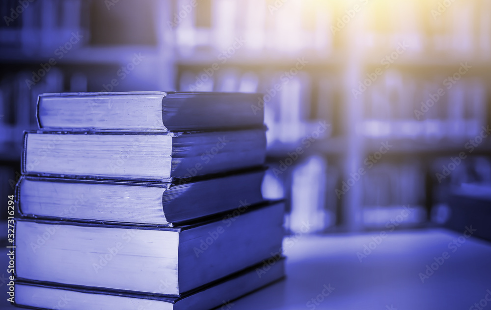 Poster stack of books in the library and blur bookshelf background