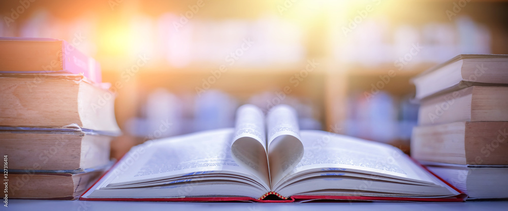 Poster stack of books in the library and blur bookshelf background
