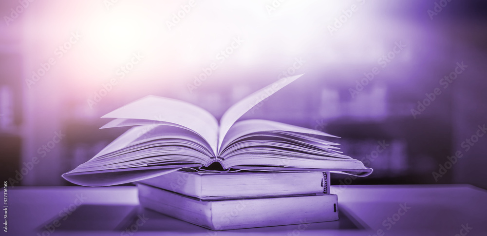 Poster stack of books in the library and blur bookshelf background