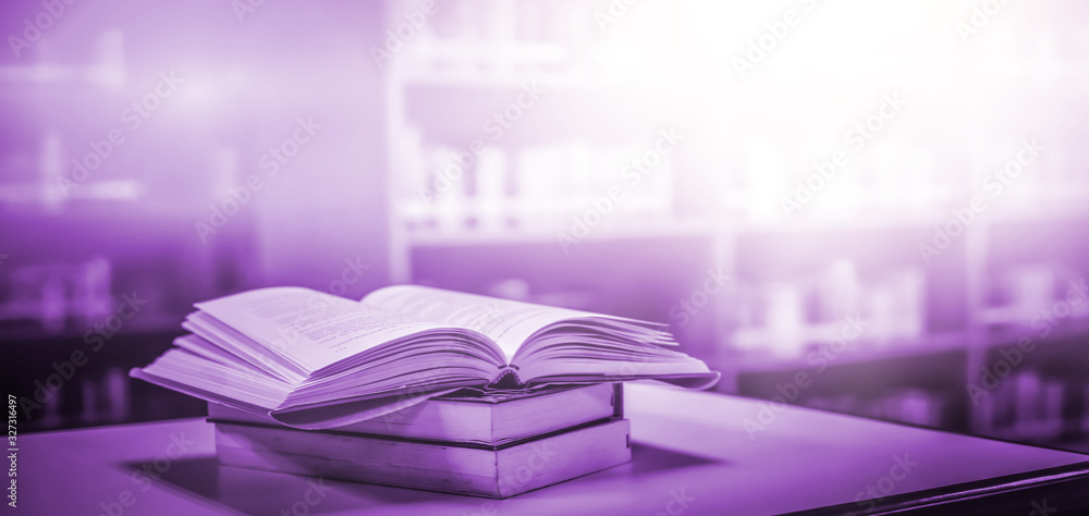 Poster stack of books in the library and blur bookshelf background