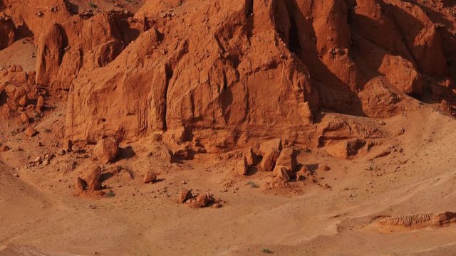 Bayanzag flaming cliffs at sunset in Mongolia, found in the Gobi Desert, zoom out view 4k